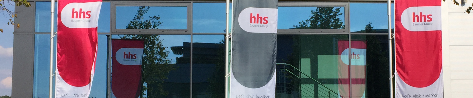 Baumer hhs building with company flags